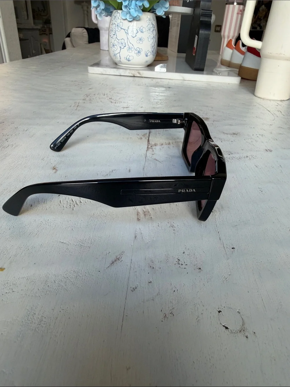 Prada Black Frame Sunglasses with Rose-Tinted Lenses